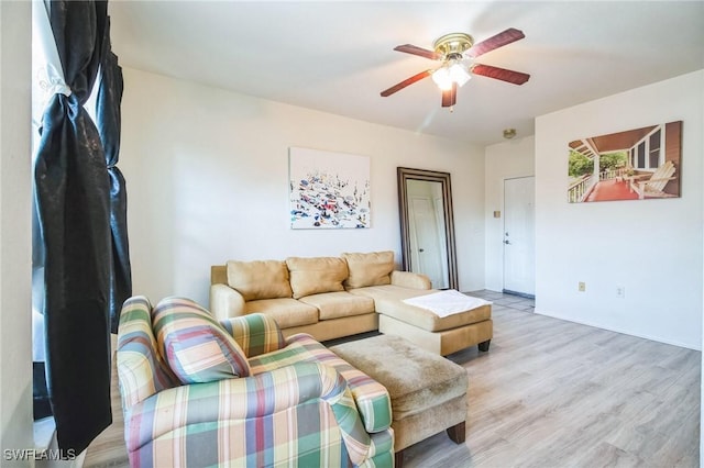 living room featuring light hardwood / wood-style floors and ceiling fan