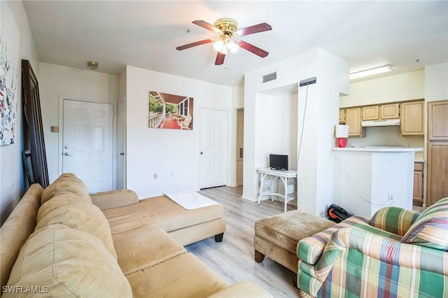 living room with ceiling fan and light hardwood / wood-style flooring