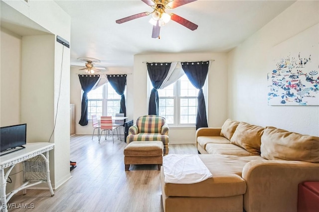 living room featuring ceiling fan and light hardwood / wood-style flooring