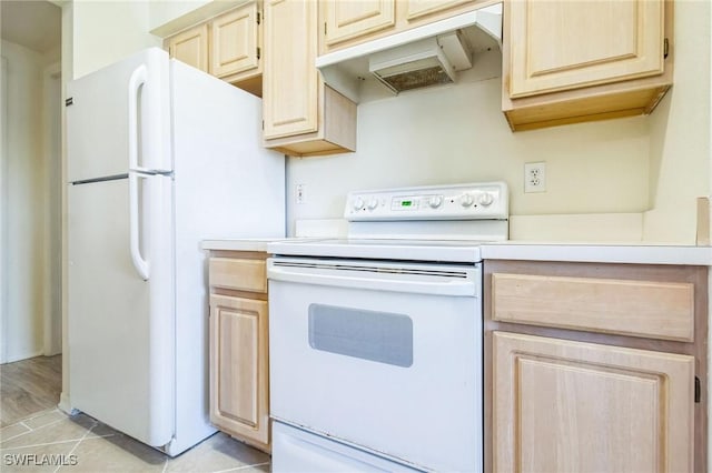 kitchen with light tile patterned floors, light brown cabinetry, and white appliances