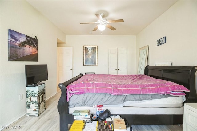 bedroom with ceiling fan, light hardwood / wood-style floors, and a closet