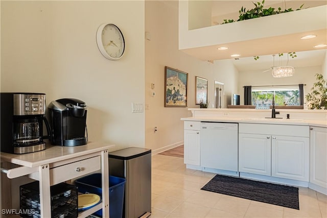 kitchen featuring baseboards, a sink, light countertops, white cabinets, and dishwasher