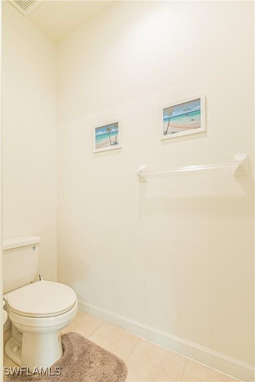 bathroom with tile patterned floors, toilet, visible vents, and baseboards