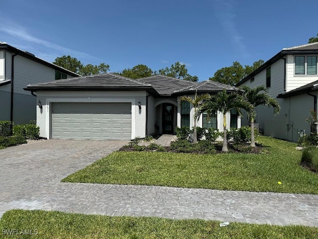 view of front of property with a garage and a front lawn