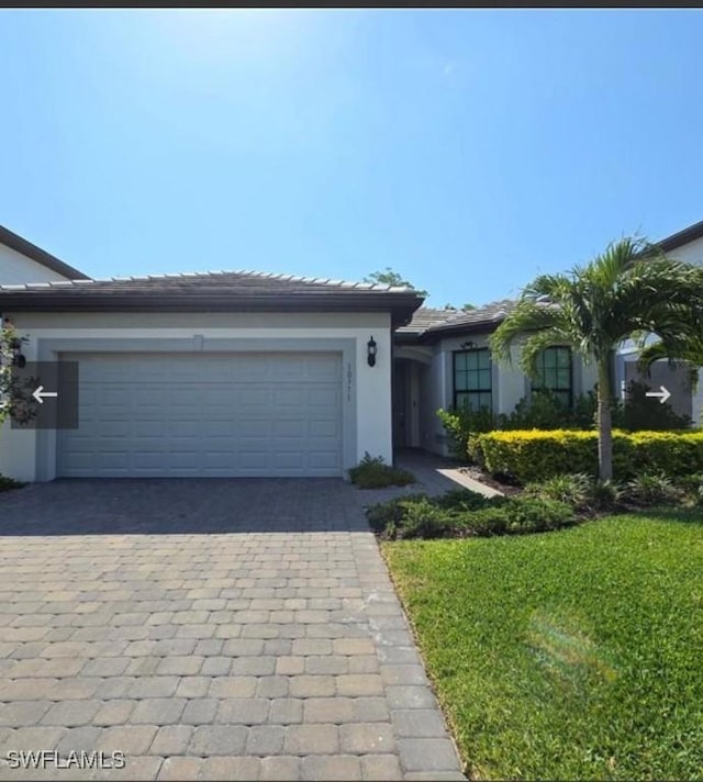 view of front of house with a garage and a front yard