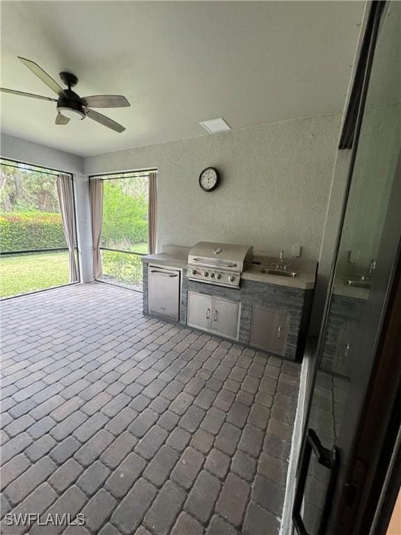 view of patio / terrace featuring exterior kitchen, area for grilling, sink, and ceiling fan