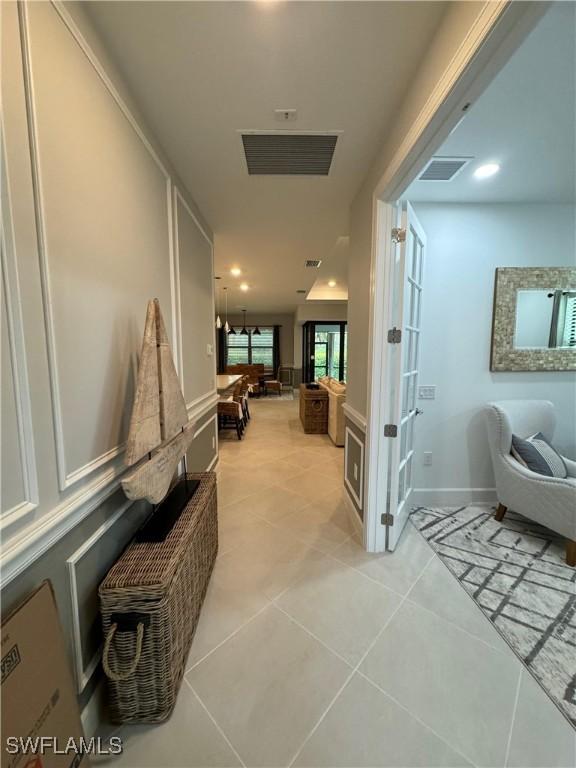 hallway featuring light tile patterned floors