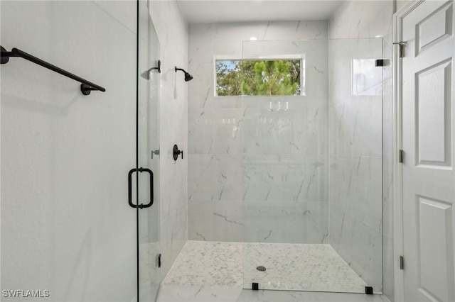 bathroom with a shower with shower door