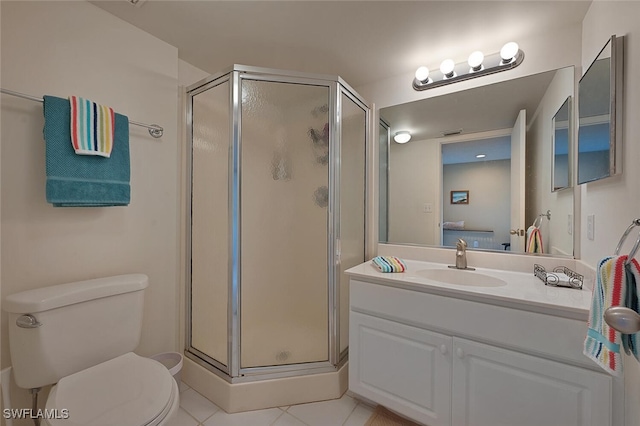 bathroom with vanity, tile patterned floors, a shower with door, and toilet