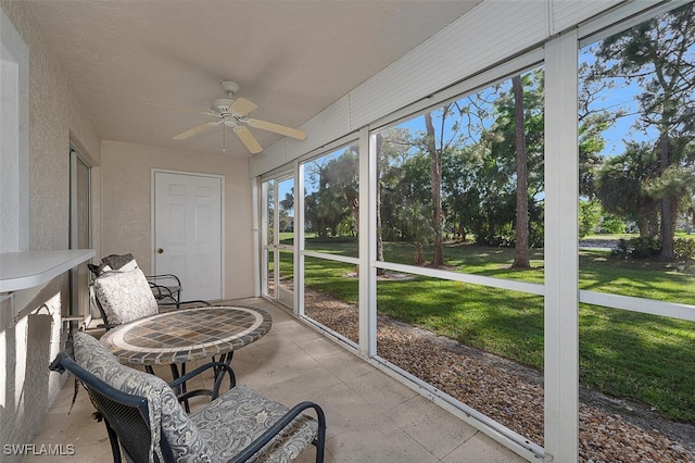 sunroom featuring ceiling fan