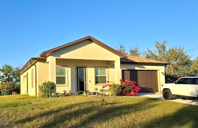 view of front of property with a garage and a front yard