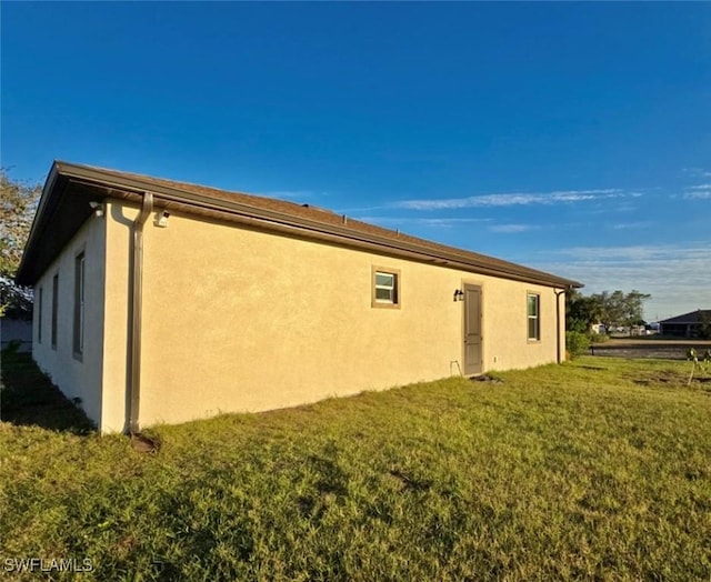 view of side of property with a yard