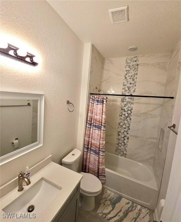 full bathroom featuring vanity, a textured ceiling, toilet, and shower / bath combo with shower curtain