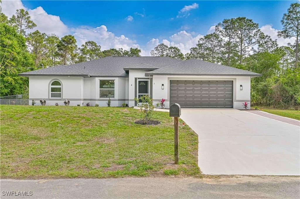 view of front of property with a garage and a front lawn