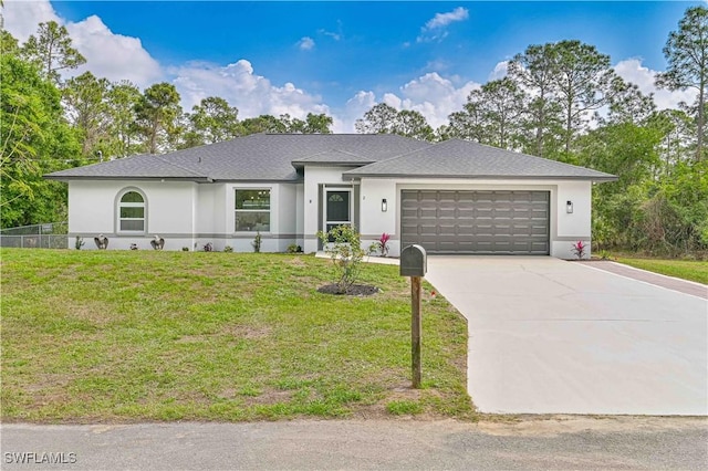 view of front of property with a garage and a front lawn