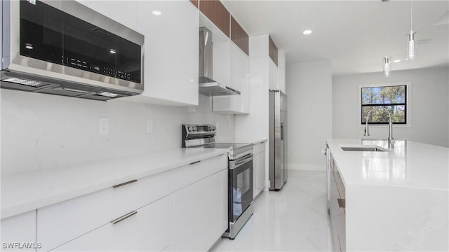 1420 Poinsettia Ave, Lehigh Acres, FL 33972 - kitchen featuring wall chimney range hood, a sink, light countertops, stainless steel appliances, and modern cabinets