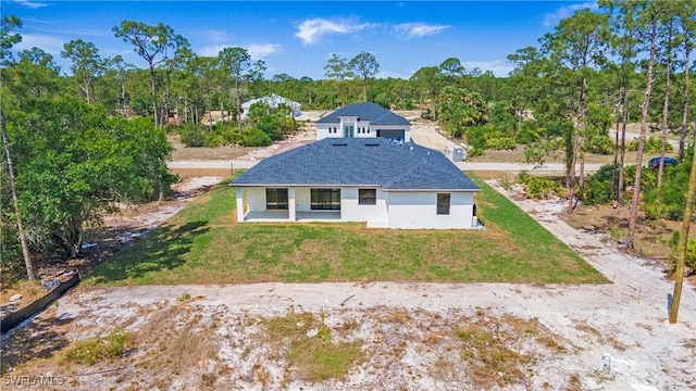 1420 Poinsettia Ave, Lehigh Acres, FL 33972 - rear view of house with stucco siding, a yard, and covered porch