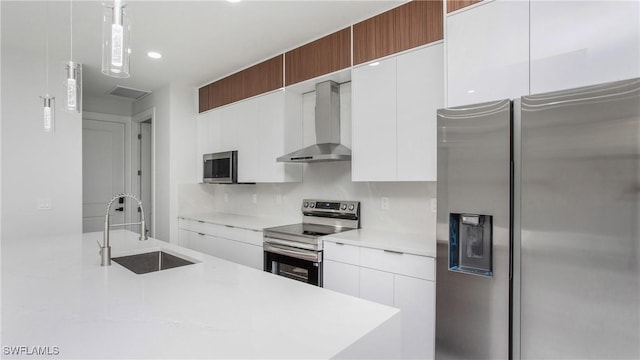 1420 Poinsettia Ave, Lehigh Acres, FL 33972 - kitchen with wall chimney range hood, modern cabinets, light countertops, a sink, and stainless steel appliances