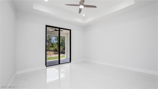 1420 Poinsettia Ave, Lehigh Acres, FL 33972 - spare room featuring marble finish floor, baseboards, ceiling fan, recessed lighting, and a raised ceiling
