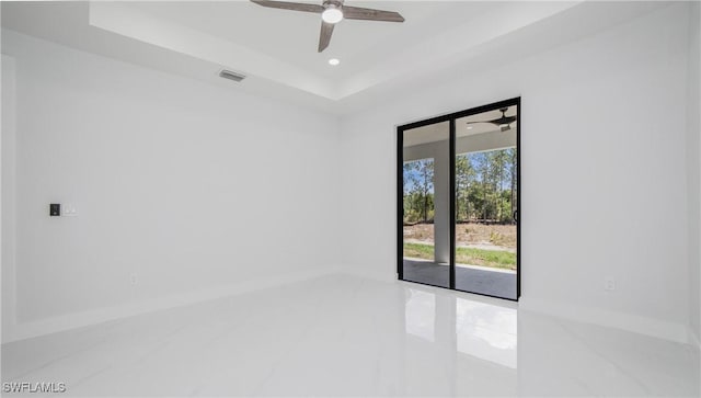 1420 Poinsettia Ave, Lehigh Acres, FL 33972 - unfurnished room featuring visible vents, a ceiling fan, and a raised ceiling