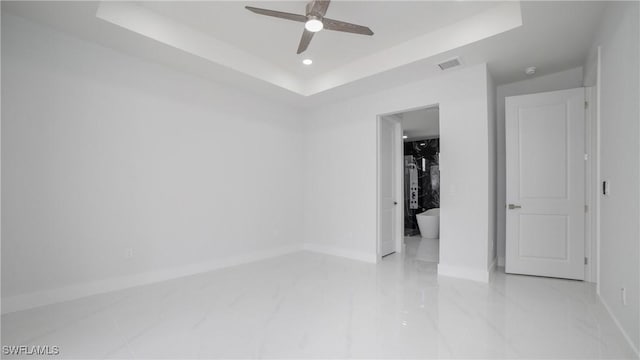 1420 Poinsettia Ave, Lehigh Acres, FL 33972 - unfurnished bedroom with visible vents, marble finish floor, baseboards, and a tray ceiling