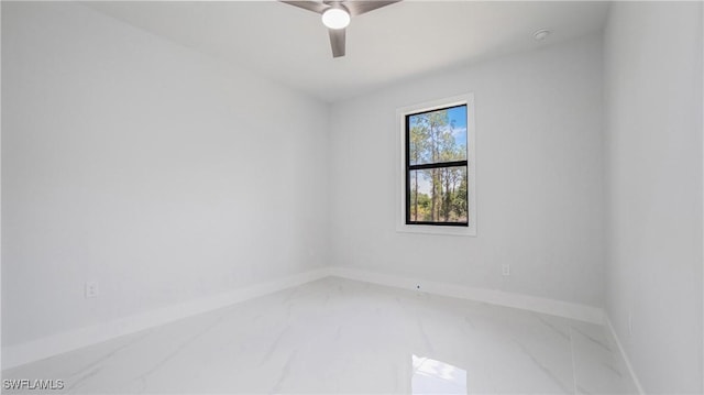 1420 Poinsettia Ave, Lehigh Acres, FL 33972 - empty room with baseboards, a ceiling fan, and marble finish floor