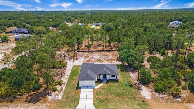 1420 Poinsettia Ave, Lehigh Acres, FL 33972 - birds eye view of property featuring a view of trees