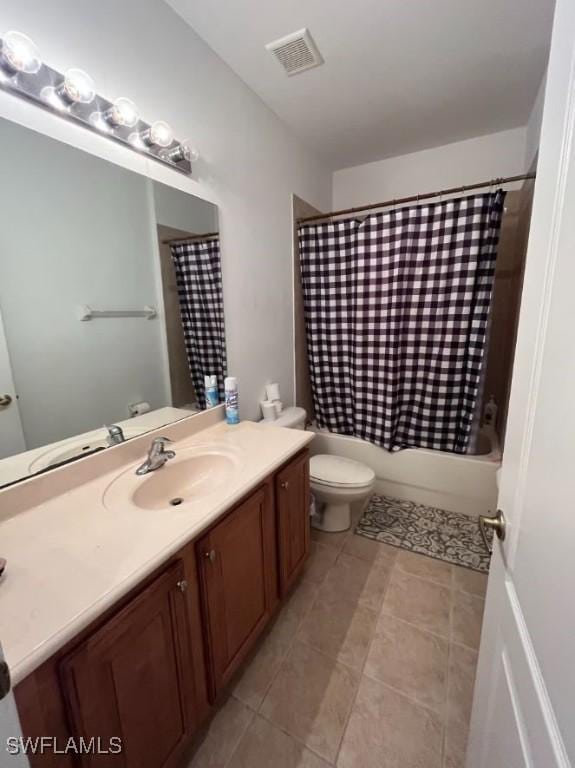 full bathroom featuring visible vents, toilet, shower / tub combo with curtain, tile patterned floors, and vanity