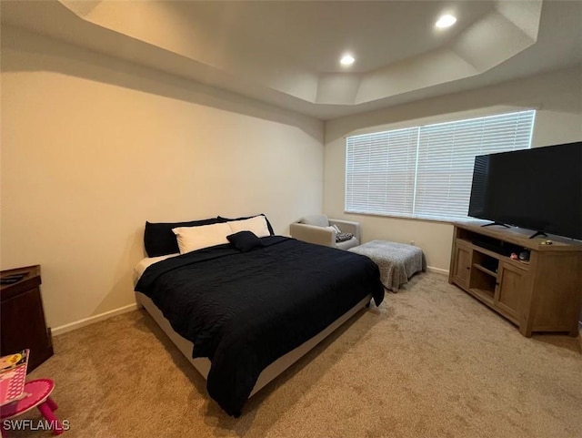 bedroom featuring light carpet, recessed lighting, a raised ceiling, and baseboards