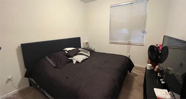 bedroom featuring carpet flooring and baseboards