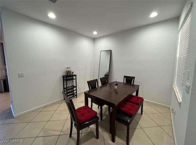 dining space with light tile patterned floors, baseboards, and recessed lighting