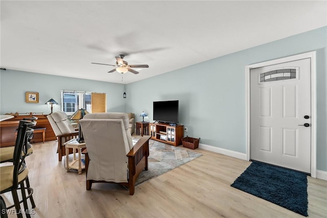 living room with ceiling fan and light hardwood / wood-style flooring