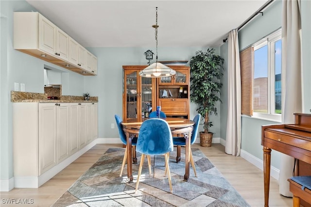 dining space with light hardwood / wood-style floors