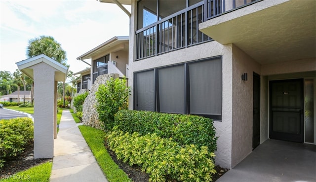 entrance to property featuring stucco siding