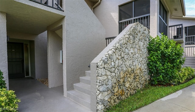 entrance to property featuring stucco siding