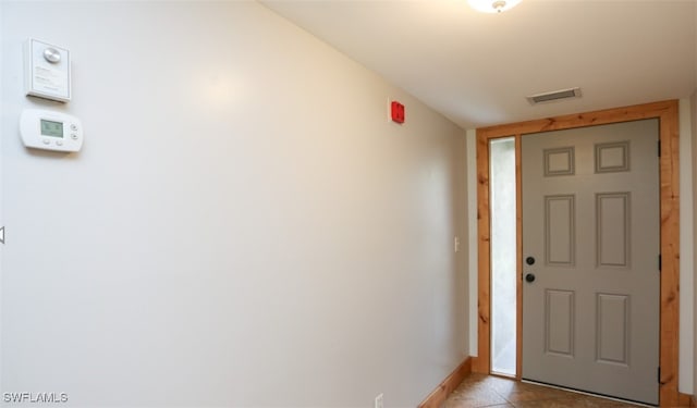 foyer entrance with visible vents and baseboards