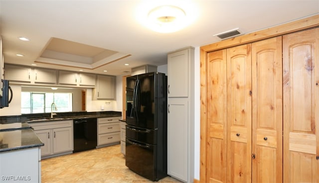 kitchen featuring recessed lighting, a raised ceiling, visible vents, a sink, and black appliances