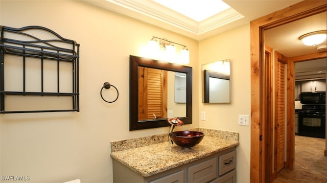 bathroom with crown molding and vanity