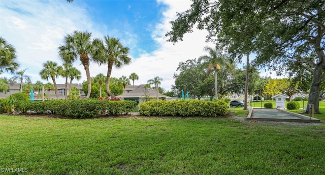 view of home's community with a yard