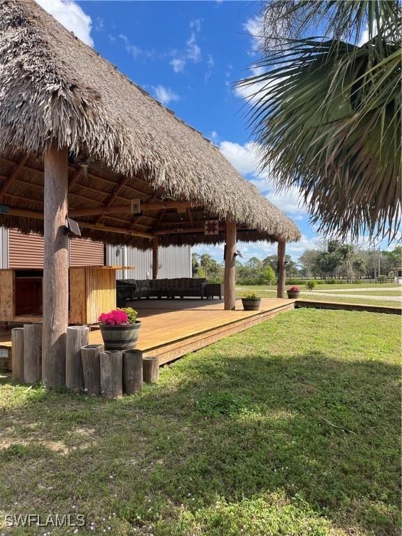 view of home's community with a gazebo, a wooden deck, and a lawn