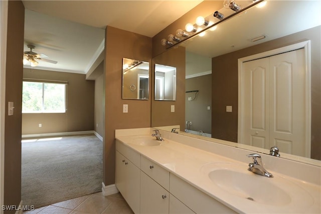 7811 Regal Heron Cir Unit 4-204, Naples, FL 34104 - bathroom with baseboards, double vanity, a ceiling fan, tile patterned flooring, and crown molding