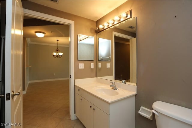 bathroom with toilet, vanity, a chandelier, baseboards, and tile patterned floors