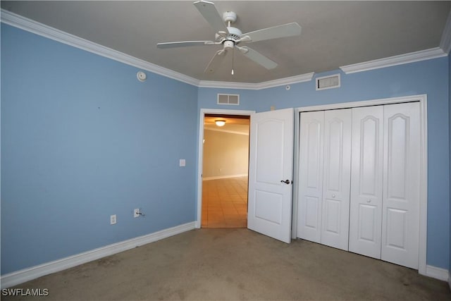 unfurnished bedroom with a closet, visible vents, crown molding, and light carpet