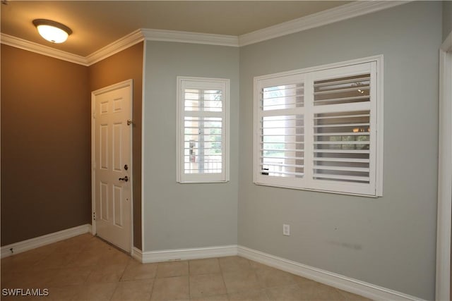 entryway featuring ornamental molding, baseboards, and light tile patterned floors