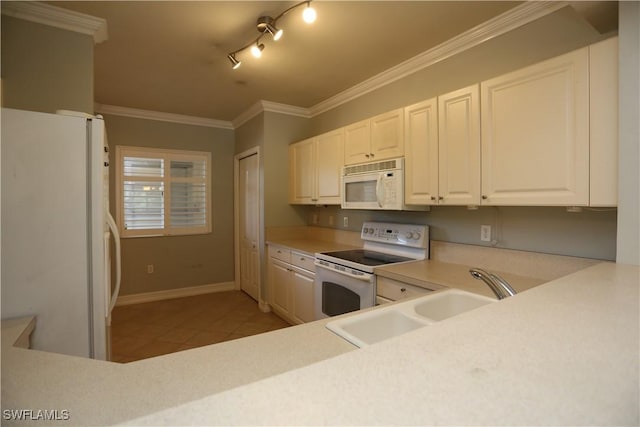 kitchen with white appliances, white cabinets, light countertops, a sink, and light tile patterned flooring