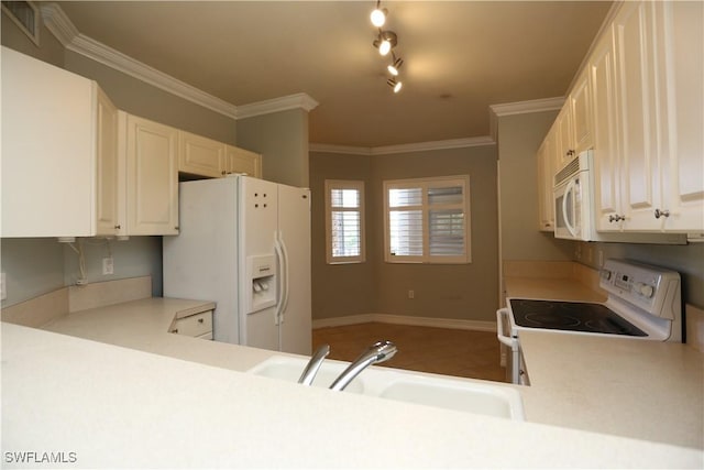 kitchen featuring light countertops, white appliances, a sink, and white cabinetry