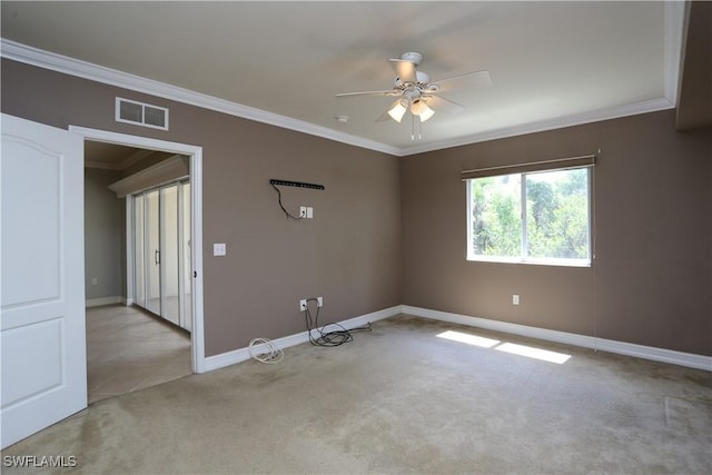 empty room with light carpet, baseboards, visible vents, and ornamental molding