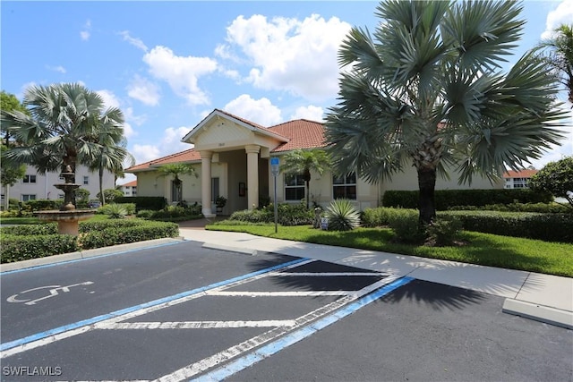 view of property featuring uncovered parking