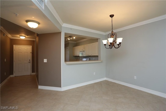 unfurnished room with baseboards, ornamental molding, and a chandelier