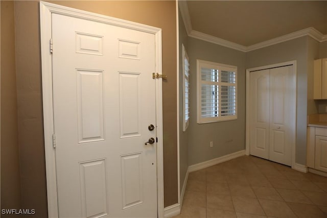 entryway with baseboards, light tile patterned flooring, and crown molding